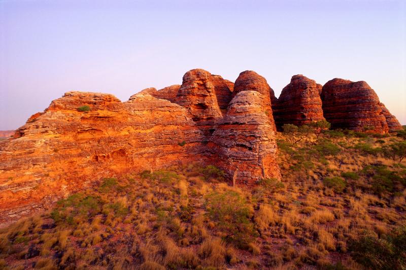  Image of red rock formations of a desert landscape at dusk.